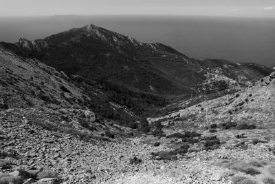 Scenic view of sea and mountains against sky