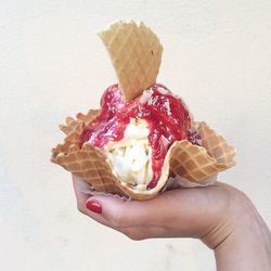 Close-up of hand holding ice cream