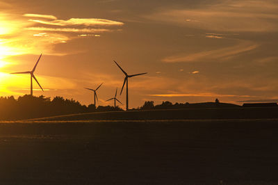 Scenic view of silhouette field against sky during sunset