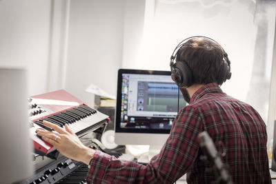 Man practicing piano at home