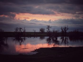 Scenic view of lake against cloudy sky