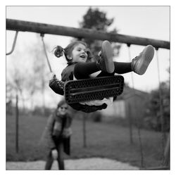 Girl swinging on swing at playground