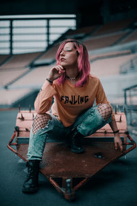 Woman looking away while sitting on seat