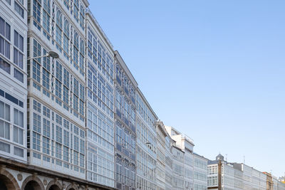 Low angle view of modern building against clear blue sky