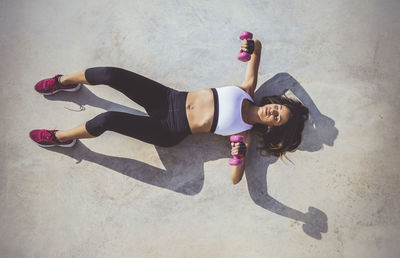 High angle view of woman working out with dumbbells