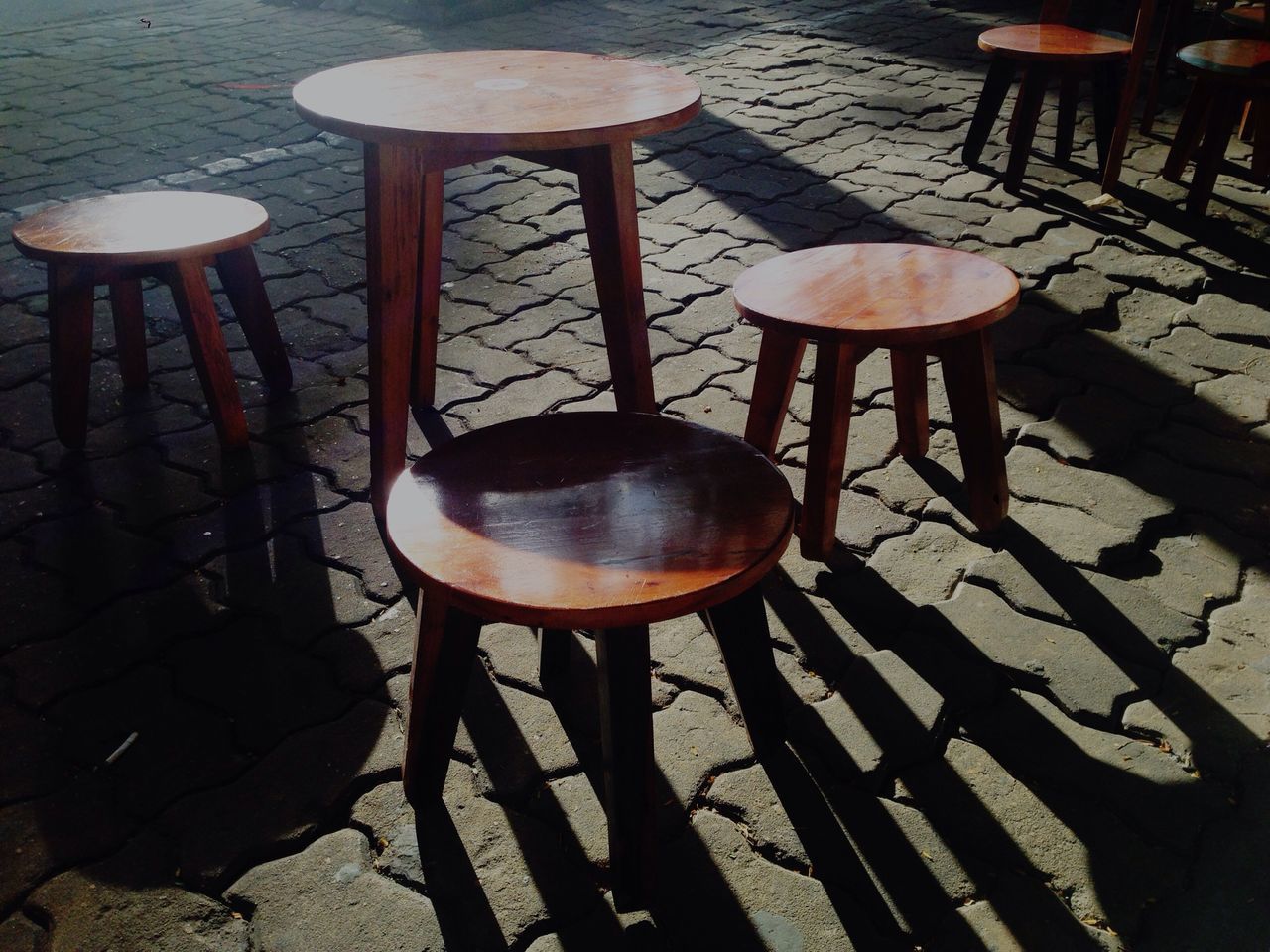 chair, table, wood - material, indoors, sunlight, empty, absence, shadow, high angle view, no people, still life, day, metal, wooden, restaurant, lighting equipment, wood, furniture, bench