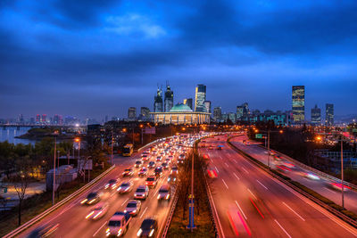 High angle view of light trails on road at night