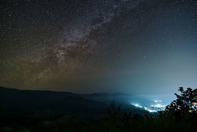 Scenic view of mountains against sky at night