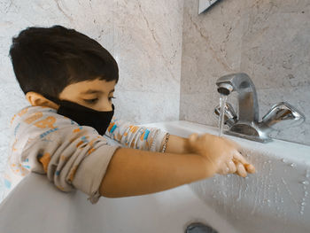 Full length of boy in bathroom at home