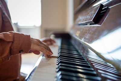 Midsection of woman playing piano