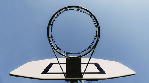 Directly below shot of basketball hoop against sky - stock photo