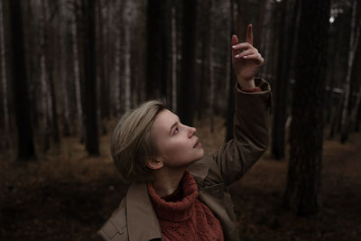 Close-up of woman standing in forest