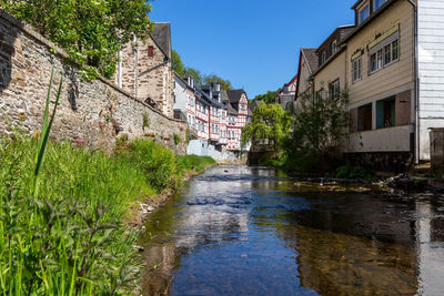 Canal amidst buildings against sky