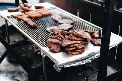 High angle view of meat on barbecue grill