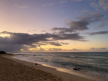 Scenic view of beach against sky during sunset