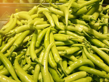 Full frame shot of green chili peppers for sale in market