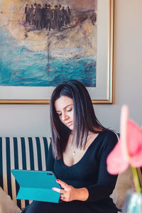 Young woman looking away at home