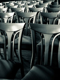 Empty chairs and table in row