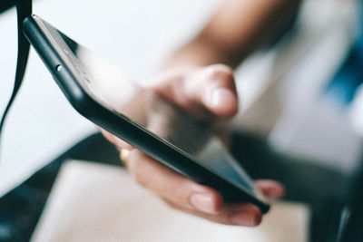 Close-up of hand holding mobile phone