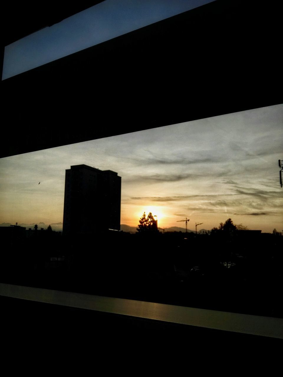 sunset, silhouette, built structure, building exterior, architecture, sky, no people, sunlight, cloud - sky, outdoors, nature, tree, beauty in nature, skyscraper, day