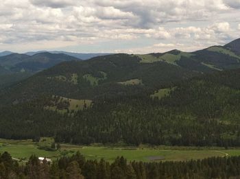 Scenic view of mountains against cloudy sky