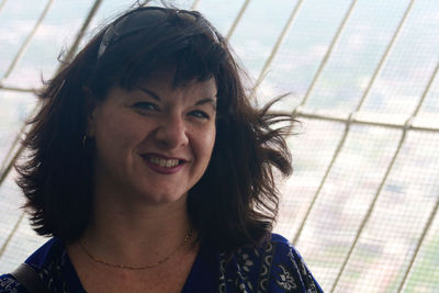 Portrait of smiling woman by window