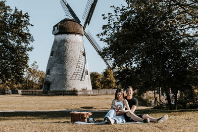 Young couple reading a book on a picnic in the park.