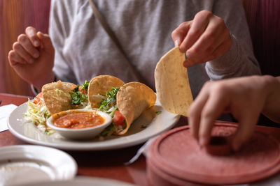 Midsection of man eating food