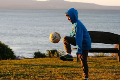 Man playing with ball in water