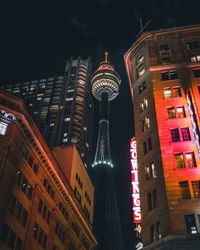 Low angle view of illuminated buildings against sky at night
