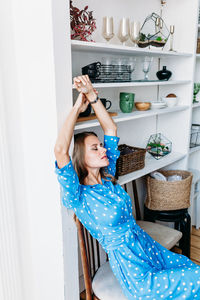 Woman sitting on chair at home