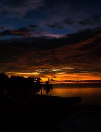 Scenic view of dramatic sky over silhouette landscape