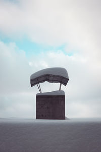 Snow covered chimney against sky