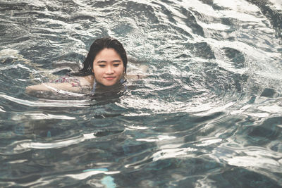 Portrait of woman swimming in sea