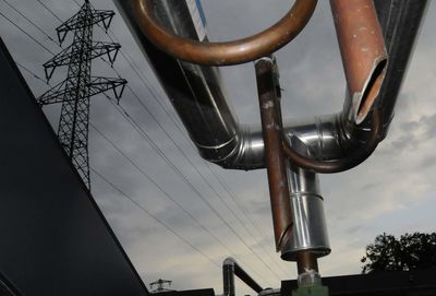 Low angle view of electricity pylon against sky