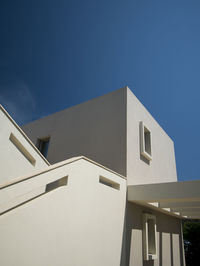 Low angle view of building against clear blue sky
