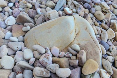 Close up of rounded and polished beach rocks on the sea shore