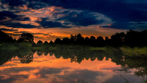 Scenic view of lake against orange sky