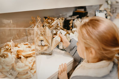 A girl choose the figurines for the christmas tree