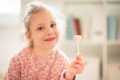 Portrait of girl holding lollipop