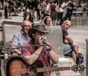 People playing guitar at music concert