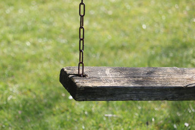 Close-up of wooden plank on field in park