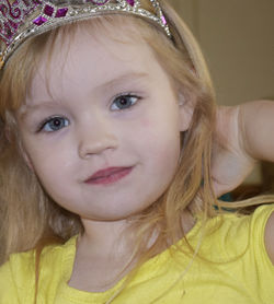 Close-up portrait of girl wearing princess crown