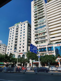 Low angle view of buildings against clear blue sky