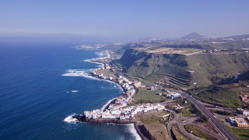 High angle view of sea and cityscape against sky