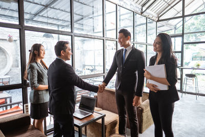 Rear view of business colleagues working in office