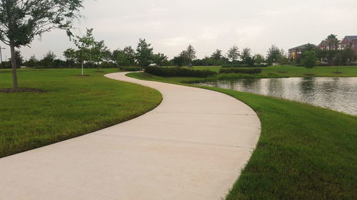 Scenic view of golf course against sky