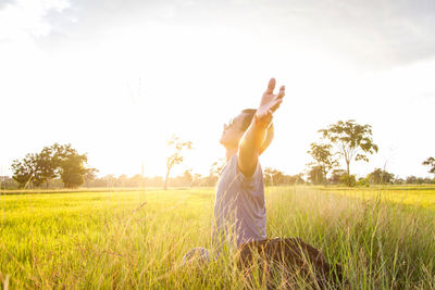 Full length of man standing on field against sky