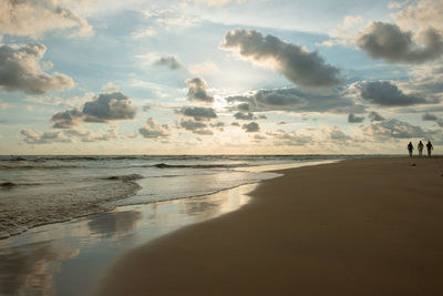 Scenic view of beach against sky during sunset