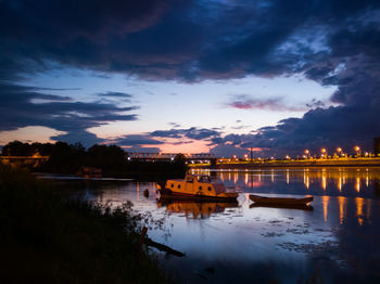 Scenic view of river against sky at sunset